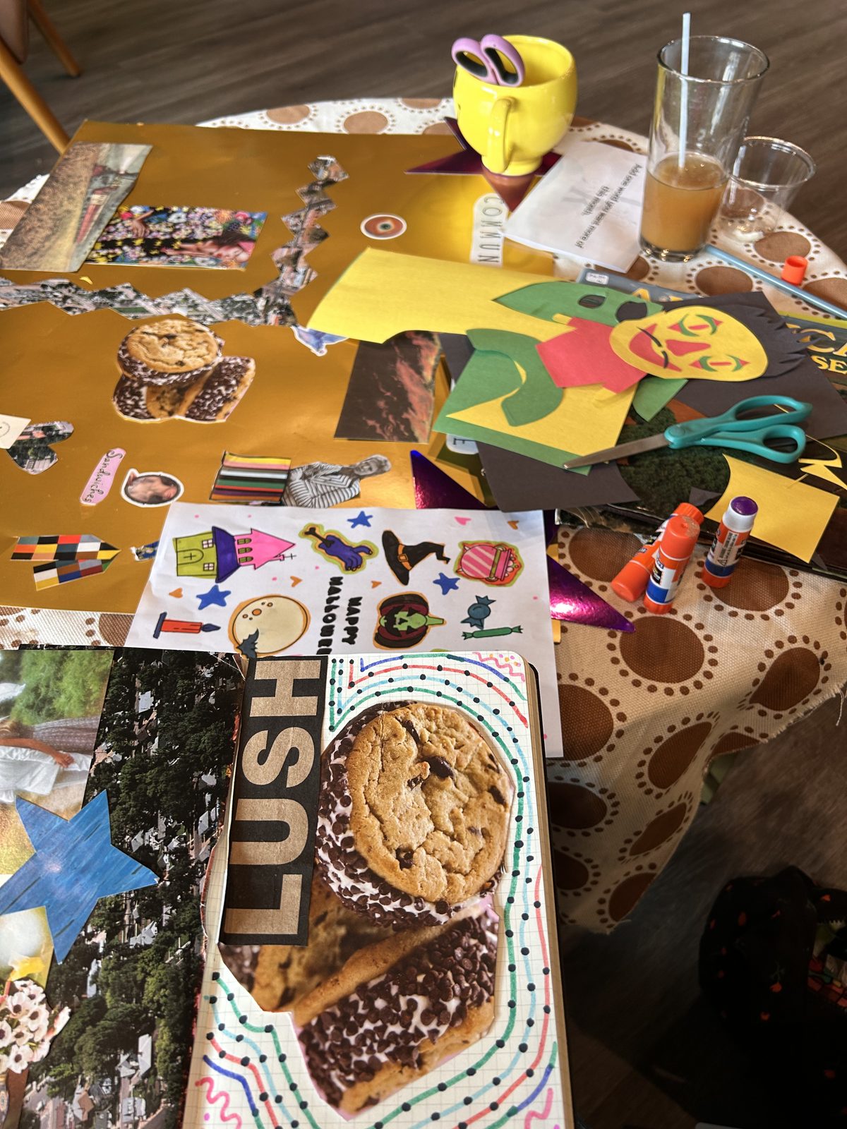 Collage supplies spread across a table at a community craft event