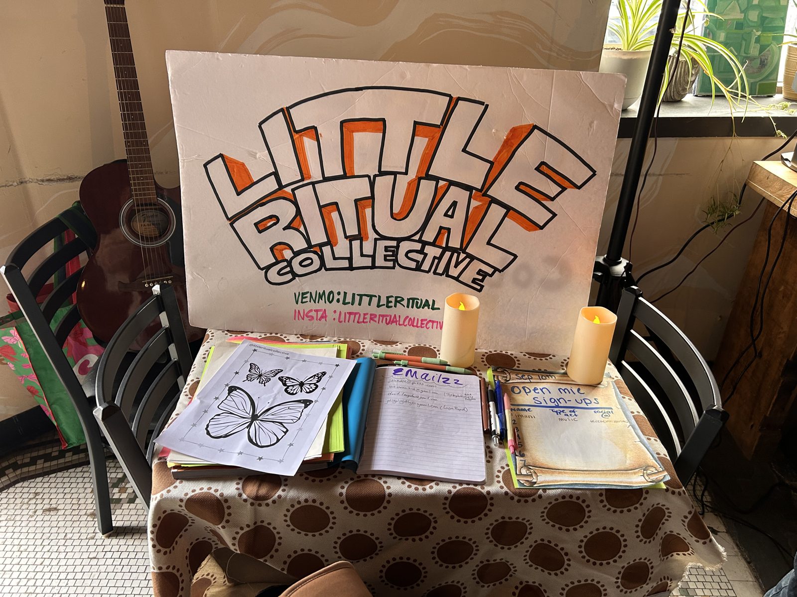 The Little Ritual Collective sign on a holographic tablecloth
